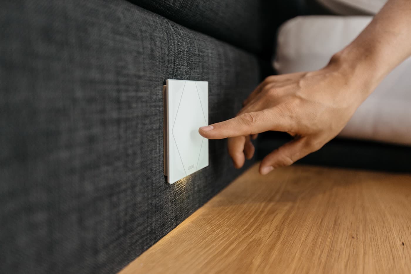 A flush glass touch control mounted on the wall