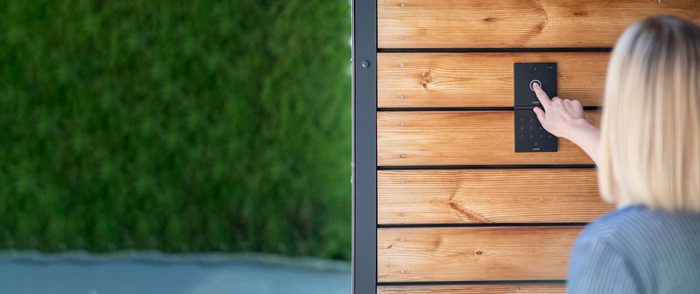 A resident answering a video intercom call inside the home