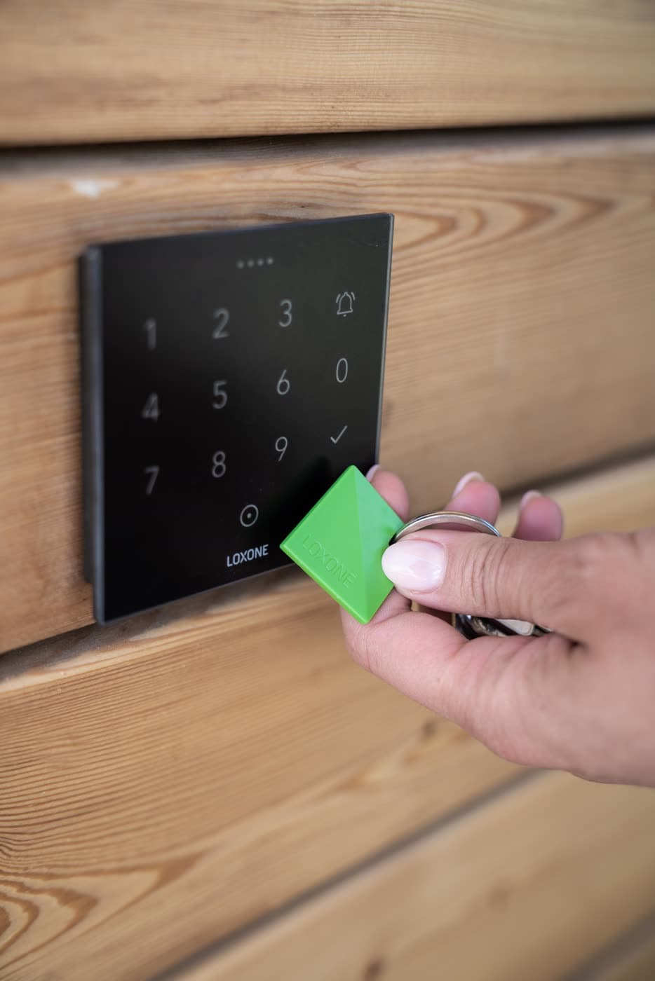 An NFC and code entry pad mounted beside a door
